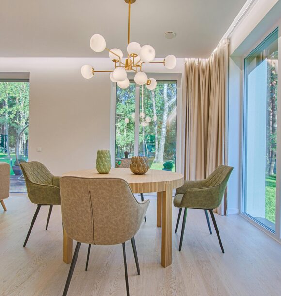 Elegant dining room featuring modern furniture and large windows for natural light.